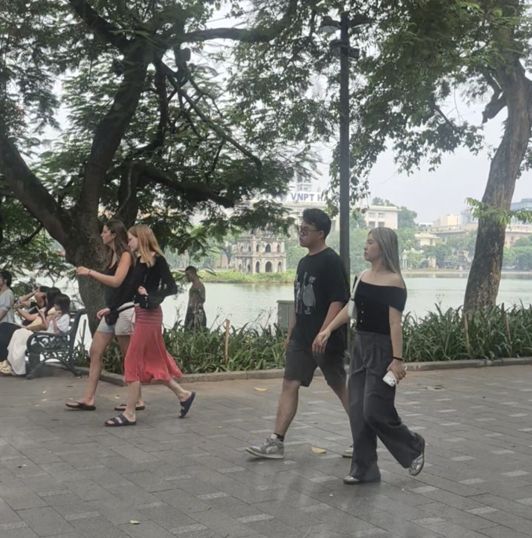 Visitors walking around Hoan Kiem Lake in Hanoi